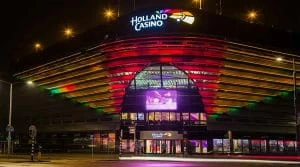 The front entrance of Holland Casino Scheveningen, The Hague, Netherlands, lit up at night.