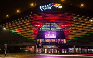 The front entrance of Holland Casino Scheveningen, The Hague, Netherlands, lit up at night.