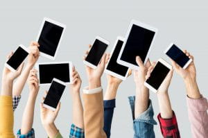 The image shows people’s raised arms and hands as they demonstrate their IOS devices. They express their satisfaction with the new sportsbook and IOS app