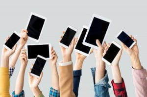 The image shows people’s raised arms and hands as they demonstrate their IOS devices. They express their satisfaction with the new sportsbook and IOS app