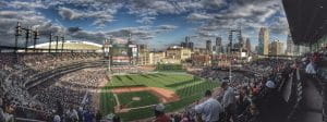 Comerica Park, the home field of the Detroit Tigers with Ford Field football stadium to the left and the Detroit skyline to the right.