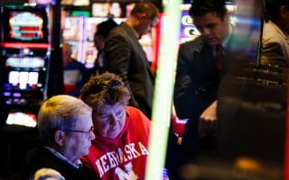 Woman wearing University of Nebraska sweatshirt while playing Slots at the Ponca tribe's Prairie Flower Casino