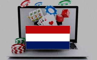 The Flag of the Netherlands in front of a laptop that represents online gambling, with chips, cards, and slot reels