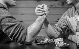 Men betting on arm-wrestling