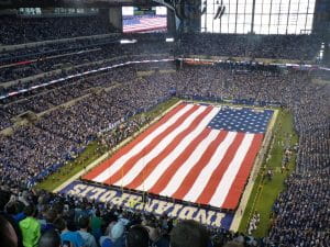 Lucas Oil Stadium, the home field of the Indianapolis Colts covered in the American Flag for the rendition of the United States’ National Anthem