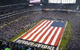 Lucas Oil Stadium, the home field of the Indianapolis Colts covered in the American Flag for the rendition of the United States’ National Anthem