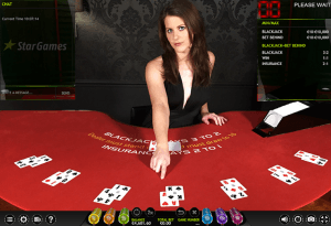 Live Casino Blackjack female dealer for Star Games at red felt table.