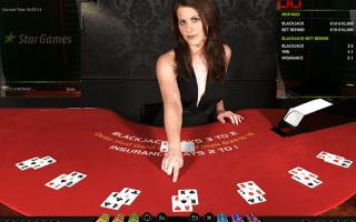 Live Casino Blackjack female dealer for Star Games at red felt table.