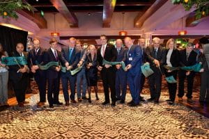 Officials and representatives are cutting the ribbon at the grand opening of the Casino Resort in New York