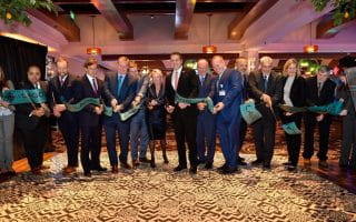 Officials and representatives are cutting the ribbon at the grand opening of the Casino Resort in New York