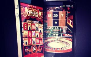 Two mobile devices, an iPhone and Android phone, displaying an online casino mobile, including online Slots and online Roulette.