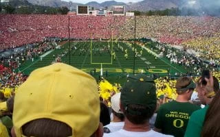 Oregon football fans watching the Oregon marching band perform during halftime of a Rose Bowl game