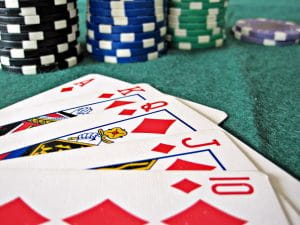 A Royal Flush in diamonds on the felt of a poker table to represent Online Poker popularity in Pennsylvania.
