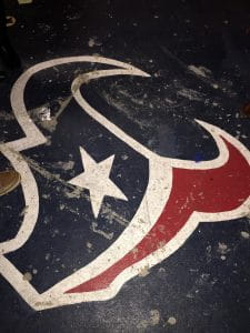 A Houston Texans logo featuring red and blue longhorns of a bull.