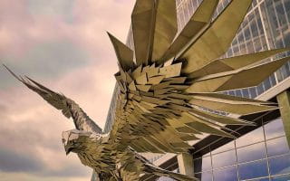 A metallic statue of a falcon grasping a football outside of Mercedes Benz Stadium, the home field of the NFL’s Atlanta Falcons