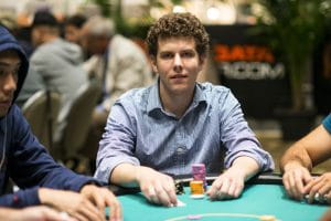 Ari Engel sitting on a poker table