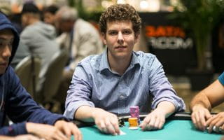 Ari Engel sitting on a poker table