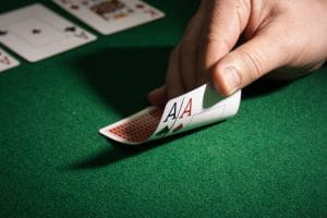 A hand holding two axes cards on a table