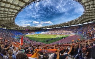 Sport fans watching a match in a stadium