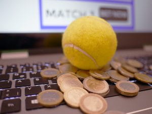 Laptop, coins and a tennis ball