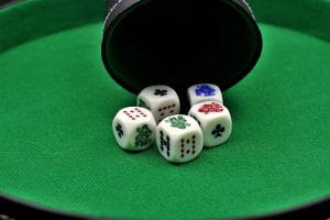 Five dices on a poker table