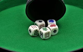 Five dices on a poker table