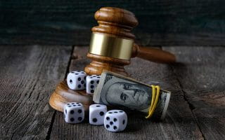 A Judge Gavel, 100 Dollar Bills and Dices