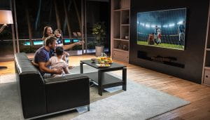 A Happy Family in front of the TV During a Soccer Game 