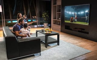 A Happy Family in front of the TV During a Soccer Game