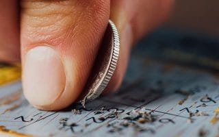 A Man is Scratching a Lottery Ticket