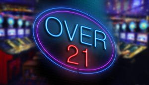A Sign Saying Over 21 with Slots in the Background