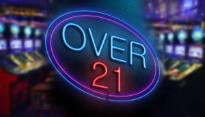 A Sign Saying Over 21 with Slots in the Background