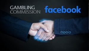 The UK Gambling Commission and Facebook Logos Over Two Hands Shaking 