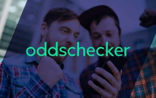 Oddschecker Name Over Two Men Reacting Victoriously While Looking at a Mobile Phone