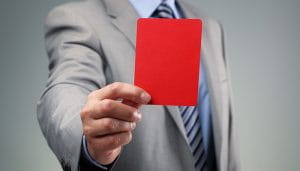 A Person in a Suit Holding a Red Card