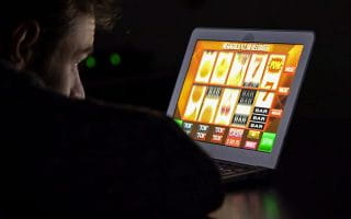 UK User Watching an Online Slot Machine on a Laptop