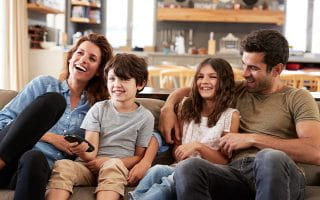 An UK Family at Their Home Watching Television