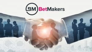 BetMakers Logo over a Picture of Businessmen Shaking Hands 