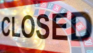 A Sign Saying Closed Over a Roulette Picture 