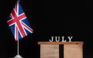 The UK Flag Next to a Sign Saying July