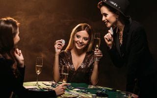 Three Women Playing Poker and Drinking Champagne