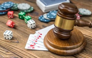 Gavel on a Table With Playing Cards, Dise, and Chips