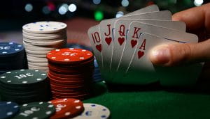 Checking Your Hand on a Poker Table with Chip 