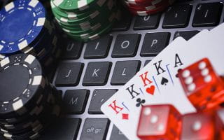 Playing cards, dice and chips on a keyboard