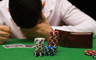 An Angry Player with a Wallet on a Casino Table