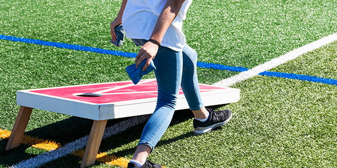 Cornhole player throwing a cornhole bag