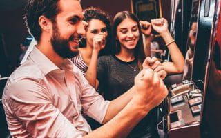 Casino player celebrating a win at the slot machines