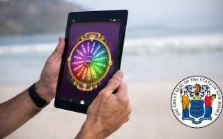 Wheel of Fortune di Tablet di sebelah Logo New Jersey