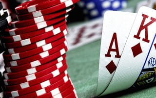 Casino Card Combination with Stacks of Chips on a Green Surface