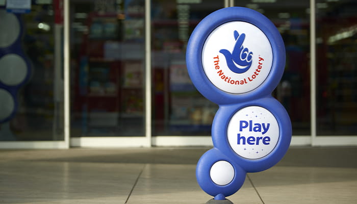 The UK National Lottery Logo Sign Infront of a Land-Based Location